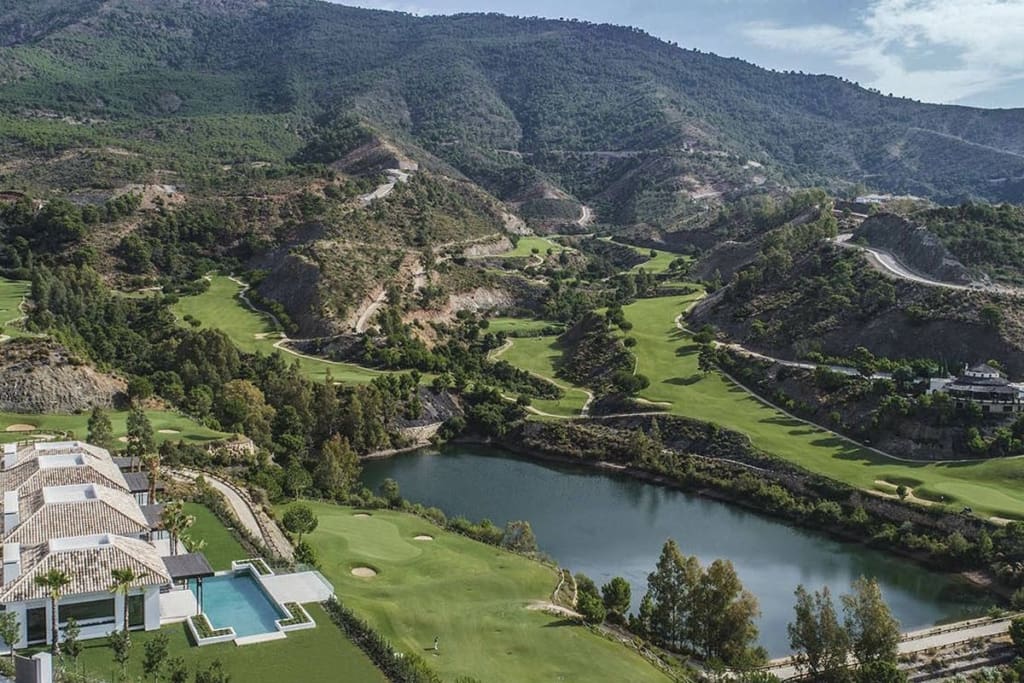 A breathtaking view of La Zagaleta, showcasing its luxurious villas, golf courses, equestrian facilities, and pristine natural surroundings in the hills of Benahavís, Costa del Sol.