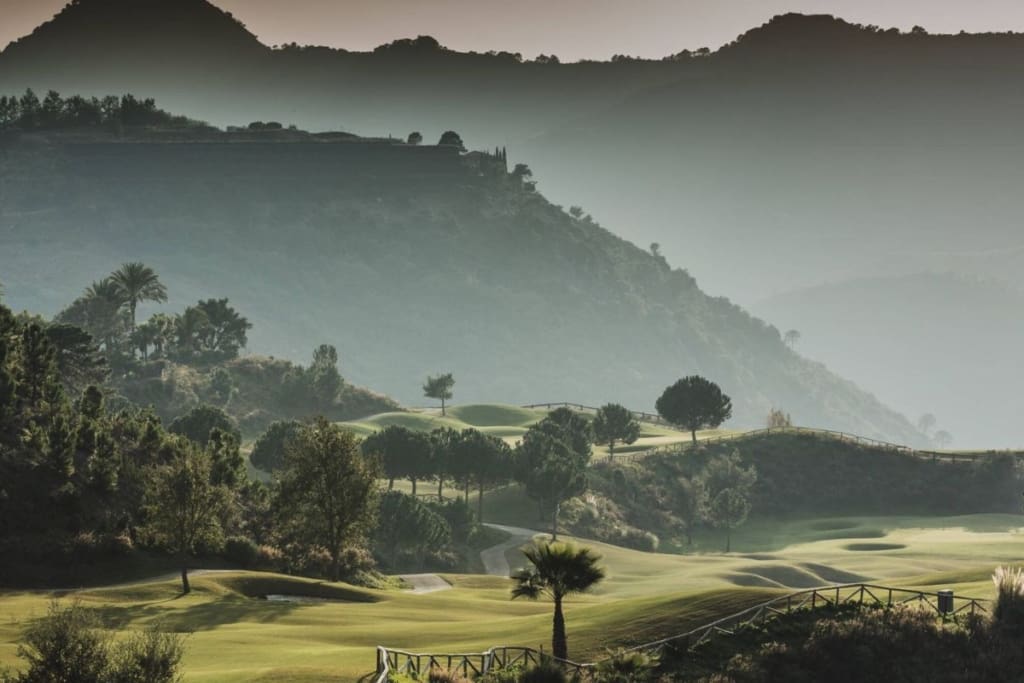 A breathtaking view of La Zagaleta, showcasing its luxurious villas, golf courses, equestrian facilities, and pristine natural surroundings in the hills of Benahavís, Costa del Sol.
